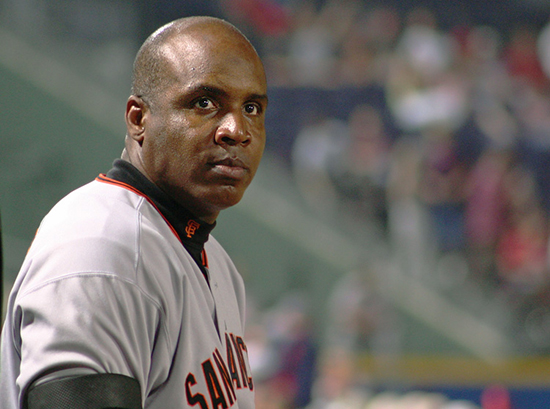 Barry Bonds standing in dugout at baseball game