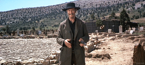 animated GIF cinemagraph showing Lee Van Cleef tossing gun from hand to hand in scene from the movie The Good, The Bad & The Ugly